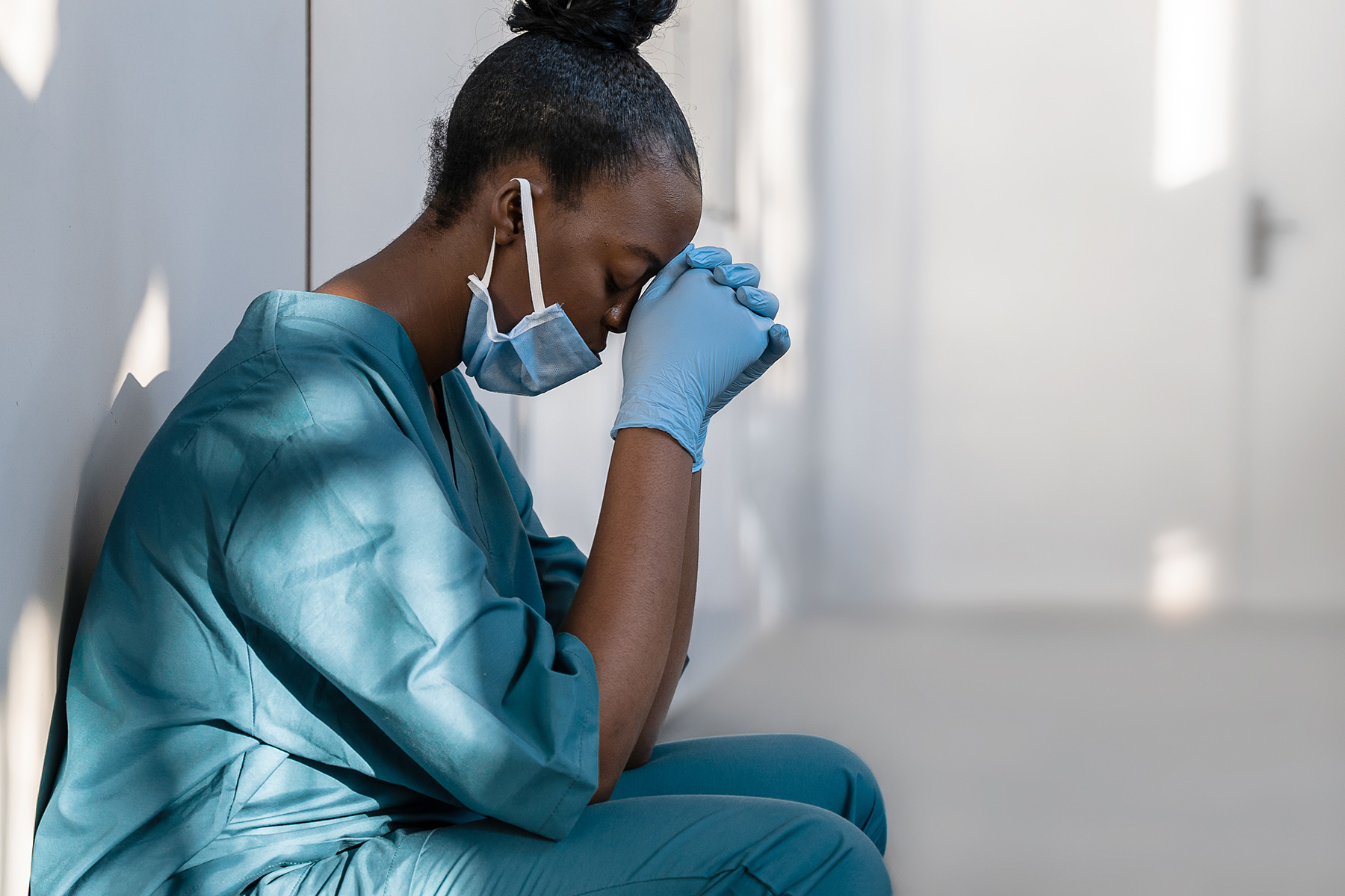 A nurse sitting outside of an operating room after some medical malpractice